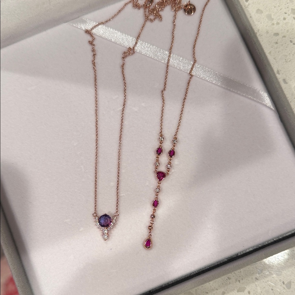 Two bomb party birthday necklaces on rose gold